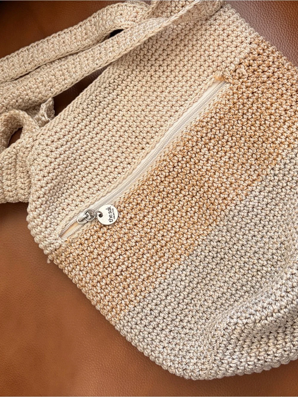 The Sak Silver Round Logo Tag on Cream Braided Accent